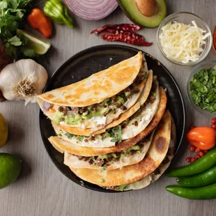a plate of quesadillas and vegetables