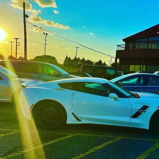 a white sports car parked in a parking lot