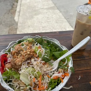 a bowl of salad and a drink