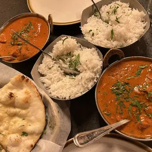 Chicken Tikka Masala (L), butter chicken (R), garlic naan and rice.