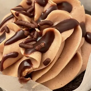 a cupcake with chocolate frosting and nuts
