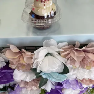 a cupcake with frosting and flowers