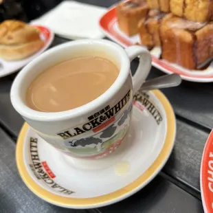a cup of coffee and a plate of bread