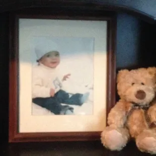 a picture of a baby and a teddy bear