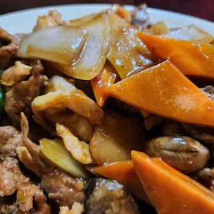 a plate of stir fried meat and vegetables