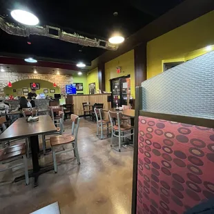 the inside of a restaurant with tables and chairs