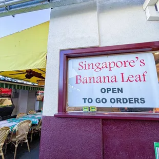 Signage in side alley way next to store front.