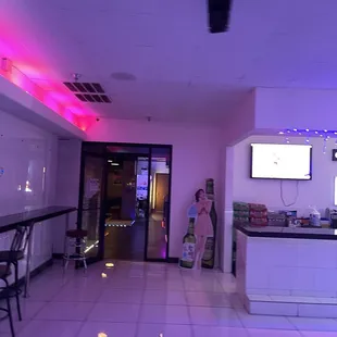 a woman standing at a bar