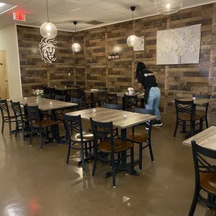 a woman sitting at a table in a restaurant