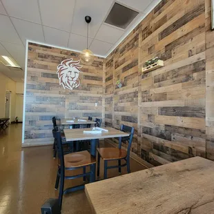 a dining area with wooden walls
