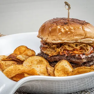 Double Beef Burger marinated in Tandoori Seasoning, Chaat Masala, Topped with Hakka Noodles, Makhani, Onions, Cheese &amp; Greens.