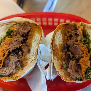 two halves of a sandwich in a basket