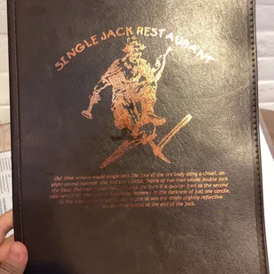 a hand holding a menu