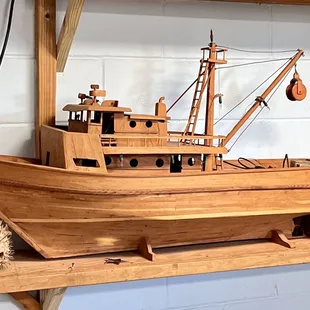 a wooden model of a fishing boat
