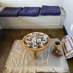 a coffee table with cups on it