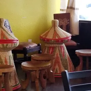 Traditional Ethiopian straw weaved baskets and sculpted wooden chairs.