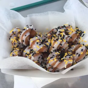 a basket of donuts with sprinkles