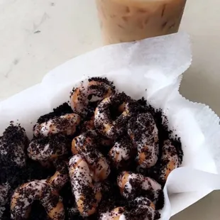 a bowl of doughnuts and a cup of coffee