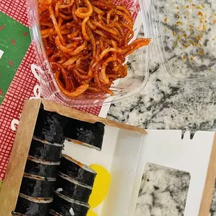 a box of sushi and a box of carrots