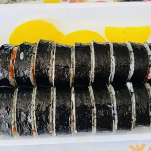 a plate of sushi rolls on a table