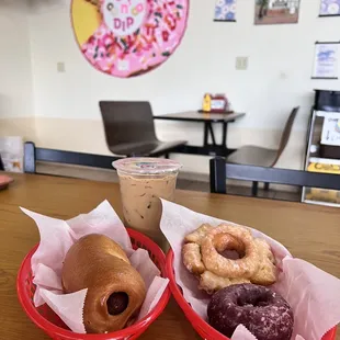 wo baskets of donuts and a drink