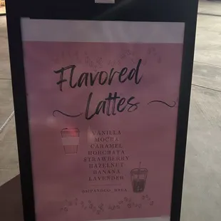 The (dimmed) board promoting the lattes