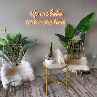 two chairs in front of a neon sign