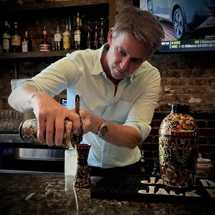 a bartender pouring a drink