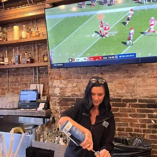 a bartender pouring a drink