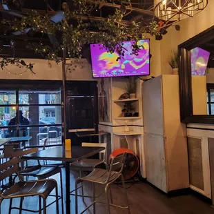 a view of a bar with a large screen tv