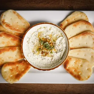 a platter of pita chips and dip
