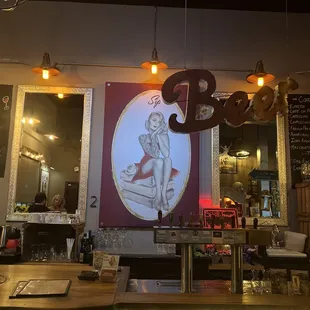 a picture of a woman sitting on a table in a restaurant