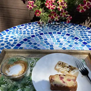 Macchiato, pistachio shortbread, cranberry loaf. On patio