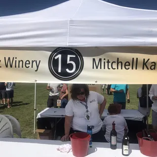 a woman standing under a tent
