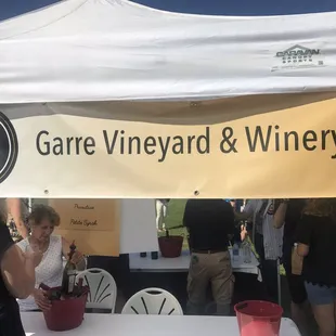 a group of people standing under a tent
