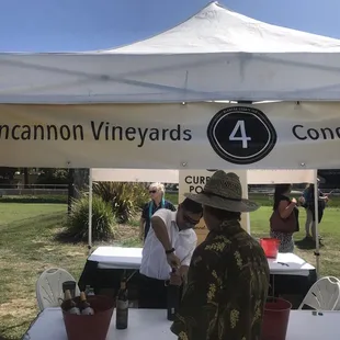 a group of people standing under a tent