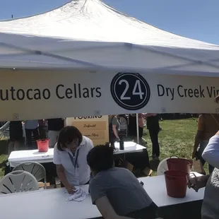 a group of people sitting under a tent