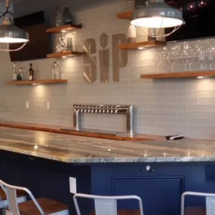 a bar with stools and a counter