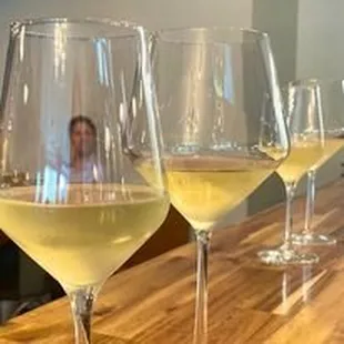 a row of wine glasses on a bar