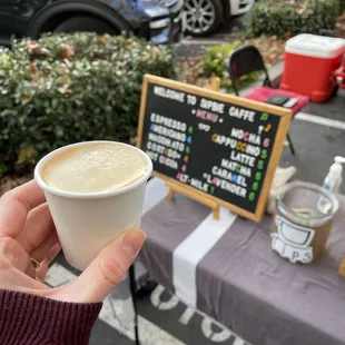 a person holding a cup of coffee