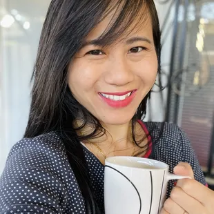 a woman holding a cup of coffee