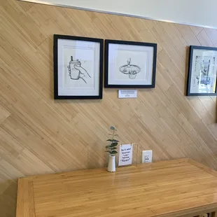 a wooden table and two framed pictures