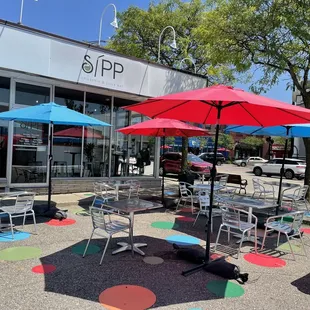 tables and umbrellas in front of a restaurant