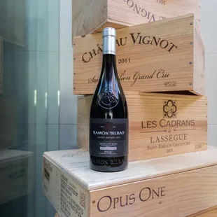  a bottle of wine on a stack of wooden boxes
