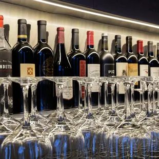  a row of wine glasses on a bar