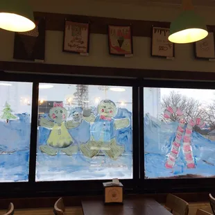 Cute Christmas decor and kids' artwork hung around the ceiling!