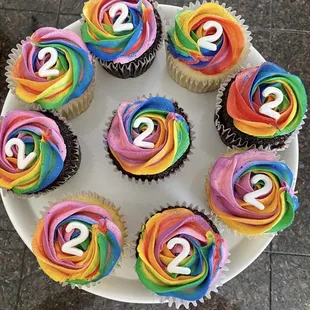 Rainbow themed 2 year old birthday cupcakes.