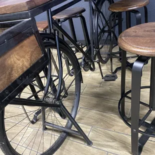 a row of bar stools and a bicycle