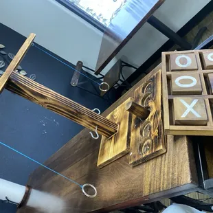 a wooden table with a tic - tac - tac - toe game on it