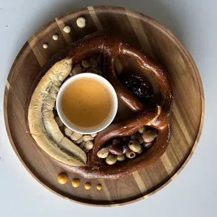 a pretzel, bananas, nuts, and a cup of tea